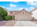 Charming home with a two-car garage, neutral paint, and well-manicured shrubs at 943 Sedona Rd, Henderson, NV 89014