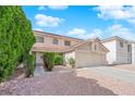 Charming home with a two-car garage, neutral paint, and well-manicured shrubs at 943 Sedona Rd, Henderson, NV 89014
