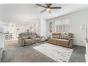 Inviting living room with comfortable seating, neutral decor, and plenty of natural light with access to kitchen at 1364 Cerulean Ave, Henderson, NV 89002