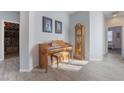 Open living space featuring wood-look floors, neutral paint and a decorative wooden piano at 176 Brighton Hills Ave, Henderson, NV 89002