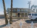 Two-story home featuring a front porch with white iron fencing and a gravel front yard at 1828 Casa Vista Dr, Las Vegas, NV 89146