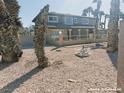 Two-story home featuring a front porch with white iron fencing and a gravel front yard at 1828 Casa Vista Dr, Las Vegas, NV 89146