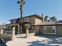 Two-story home featuring a gravel front yard, brick accents, and a covered front porch at 1828 Casa Vista Dr, Las Vegas, NV 89146