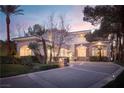 Charming two-story home featuring arched windows, a tile roof, and a beautifully landscaped front yard at 2041 Troon Dr, Henderson, NV 89074