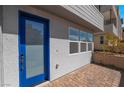 Inviting entryway with a blue glass door and brick paved porch at 2509 Silent View Ave, Henderson, NV 89044