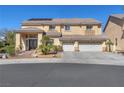 Spacious two-story home with a three-car garage and well-manicured front yard at 2566 Antique Blossom Ave, Henderson, NV 89052