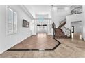 Grand foyer with soaring ceilings, elegant staircase, and tile flooring at 2566 Antique Blossom Ave, Henderson, NV 89052