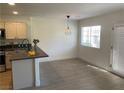 Dining area featuring a modern light fixture and natural light from the window at 2621 Adelante Ave # 102, Las Vegas, NV 89106
