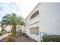 A garden-style condominium complex featuring stucco exterior, desert landscaping, and blue trim at 2725 S Nellis Blvd # 2045, Las Vegas, NV 89121