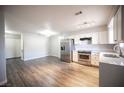 Open-concept living room and kitchen area, featuring modern stainless steel appliances and light gray walls at 2725 S Nellis Blvd # 2045, Las Vegas, NV 89121