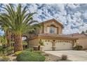 Well-maintained two-story home with desert landscaping and a two-car garage, with a blue sky backdrop at 28 Birkdale Dr, Henderson, NV 89074