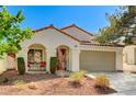 Inviting single-story home with desert landscaping, covered porch, and two car garage at 280 Pear Meadow St, Henderson, NV 89012