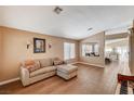 Open living room with wood tile flooring, large windows, and neutral decor at 280 Pear Meadow St, Henderson, NV 89012