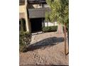 Charming home exterior featuring mature trees, inviting front entrance, and landscaped pathway at 3221 Yolanda Ln, Las Vegas, NV 89121