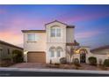 Attractive two-story home with a two-car garage, charming courtyard, and neutral stucco exterior at 352 Dandelion Brook Ct, Las Vegas, NV 89148