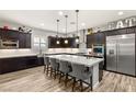 Modern kitchen featuring dark wood cabinets, stainless steel appliances, and a large center island at 352 Dandelion Brook Ct, Las Vegas, NV 89148