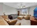 Comfortable living room with neutral tones, large windows, and ample seating for relaxation and entertainment at 4511 Townwall St, Las Vegas, NV 89115