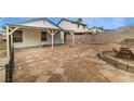 Spacious backyard featuring red and beige tile and a covered patio area, perfect for outdoor entertaining at 516 Tabony Ave, Henderson, NV 89011