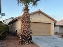 Cozy single-Gathering home with a two-car garage and neutral exterior, framed by a mature palm tree at 5182 Baldy Ln, Las Vegas, NV 89110