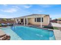 Sparkling pool with a spa, sun loungers, and a covered patio offering an ideal outdoor living space at 7420 Zonal Ave, Las Vegas, NV 89131