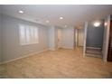 Spacious living room with neutral walls, tiled floors, shuttered windows and plenty of natural light at 8084 Bosco Bay Ave, Las Vegas, NV 89113
