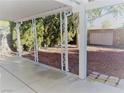View of the backyard from the covered patio, with a privacy wall and minimal landscaping at 8512 Manalang Rd, Las Vegas, NV 89123