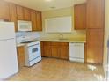 Functional kitchen features a gas range, white appliances, tile floors, and plenty of cabinet space at 8512 Manalang Rd, Las Vegas, NV 89123