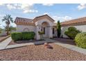 Inviting front exterior featuring a tile roof, stucco siding, and desert landscaping at 10033 Cresent Creek Dr, Las Vegas, NV 89134