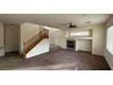 Open floor plan showcasing living room with fireplace, staircase, high ceilings, and lots of natural light at 10075 Cranbrook Falls Ct, Las Vegas, NV 89148