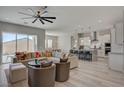 Spacious living room with light wood floors, a ceiling fan, and an open floor plan at 10197 Copper Meadow Ave, Las Vegas, NV 89166