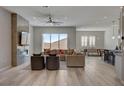 Bright open-concept living area featuring a fireplace, modern furniture and great natural light at 10197 Copper Meadow Ave, Las Vegas, NV 89166
