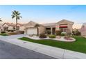 Inviting single-story home with well-manicured landscaping, vibrant green lawn, and a welcoming two-car garage at 10508 Snyder Ave, Las Vegas, NV 89134