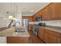 Well-lit kitchen with wood cabinets, stainless steel appliances, granite countertops, and a dual sink island at 10548 Nantucket Ridge Ave, Las Vegas, NV 89166