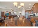 Open-concept kitchen and dining area with stainless steel appliances and wood cabinets, great for entertaining at 10548 Nantucket Ridge Ave, Las Vegas, NV 89166