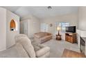 Cozy living room with a fireplace, neutral carpet, and comfortable seating furniture at 1163 Teal Point Dr, Henderson, NV 89074