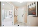 Inviting hallway featuring black and white tile, opening to a bathroom with a tub at 135 E Harmon Ave # 1919, Las Vegas, NV 89109