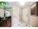 Inviting hallway with tiled floors, wet bar, and doorway to the luxurious bathroom at 145 E Harmon Ave # 819, Las Vegas, NV 89109