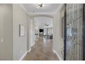 Bright foyer with archway leading to living spaces featuring tile floors and a decorative glass front door at 15 Via Mantova # 303, Henderson, NV 89011