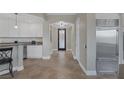 Gourmet kitchen with breakfast bar, pendant lights, stainless steel refrigerator and decorative front door at 15 Via Mantova # 303, Henderson, NV 89011
