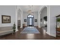 Grand foyer boasts elegant lighting, high ceilings, and hardwood flooring at 1901 Rosemere Ct, Las Vegas, NV 89117