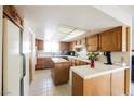 Traditional kitchen featuring wood cabinets, a large center island, and white countertops with a tile backsplash at 2004 Canterbury Dr, Las Vegas, NV 89119