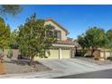 Charming stucco two-story home with a three-car garage and desert landscaping at 2236 Midvale Ter, Henderson, NV 89074