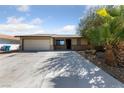 Single story home with desert landscaping, spacious driveway, and attached garage at 2637 Rialto Rd, Las Vegas, NV 89108