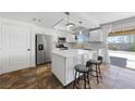 Updated kitchen featuring stainless steel appliances, quartz countertops, and a center island with seating at 2637 Rialto Rd, Las Vegas, NV 89108