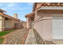 Home front exterior with landscaped walkway, stone accents, and a covered entryway at 2802 Secret Canyon Rd, Las Vegas, NV 89074