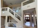 Open staircase design with glass railing details, with abundant natural light in a spacious foyer at 3917 White Castle St, Las Vegas, NV 89129