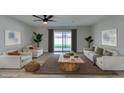 Bright living room features modern ceiling fan, contemporary furnishings, and sliding doors to the backyard at 5800 Balzar Ave, Las Vegas, NV 89108