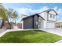 Recently remodeled two-story house displaying artificial turf, a tree and a view of the backyard at 6407 Spring Meadow Dr, Las Vegas, NV 89103