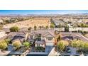 Aerial view of a home with a desert landscape, tile roof, and proximity to neighborhood amenities at 7293 Iron Oak Ave, Las Vegas, NV 89113