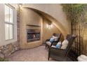 Cozy outdoor fireplace with comfortable seating in a charming courtyard setting at 7307 Iron Oak Ave, Las Vegas, NV 89113